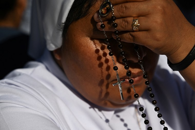 A nun holds a rosary at the Vatican on Thursday.