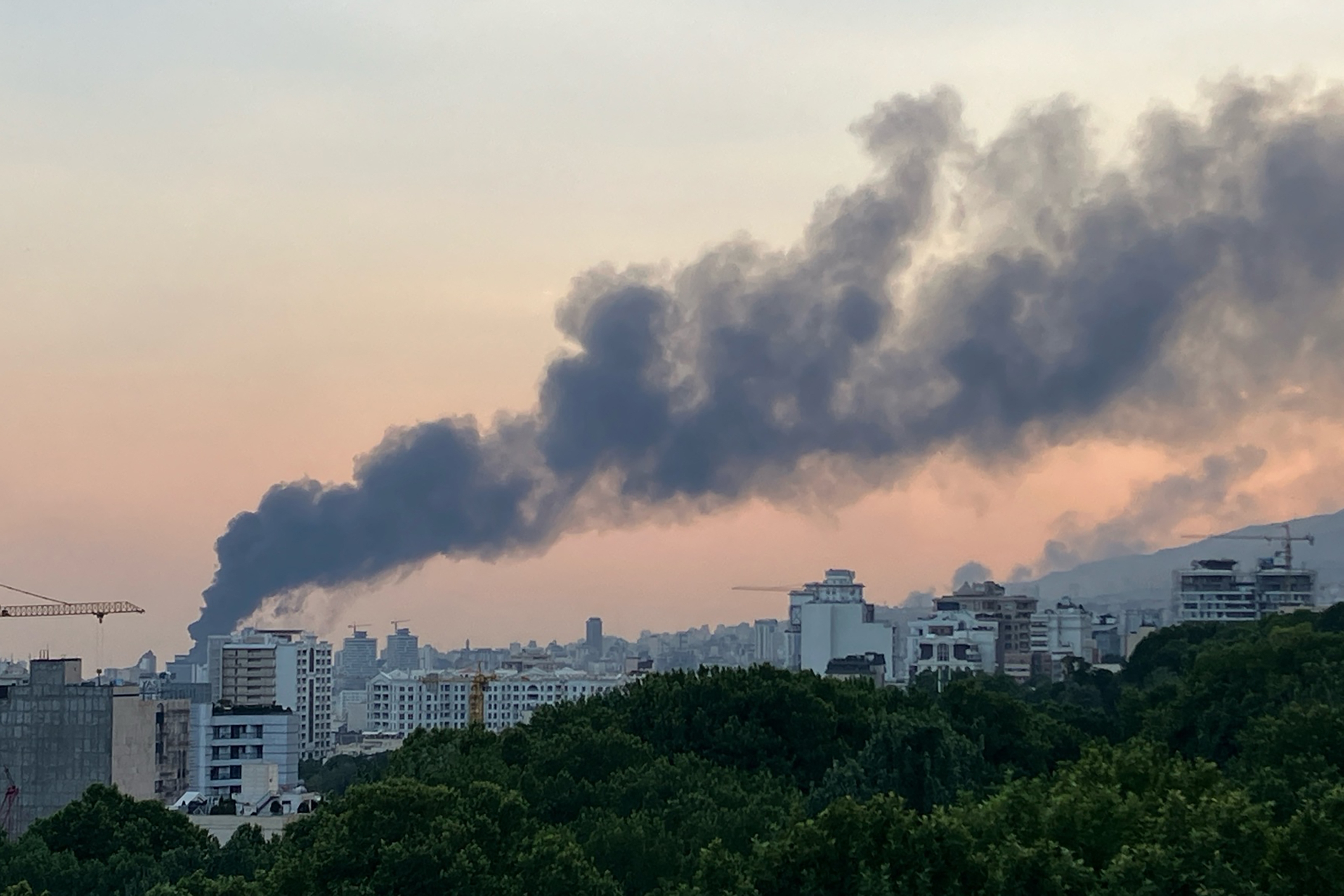 Smoke billows from an explosion at the Islamic Republic of Iran Broadcasting (IRIB) building in Tehran after an Israeli strike hit the building, cutting off live coverage, on June 16.