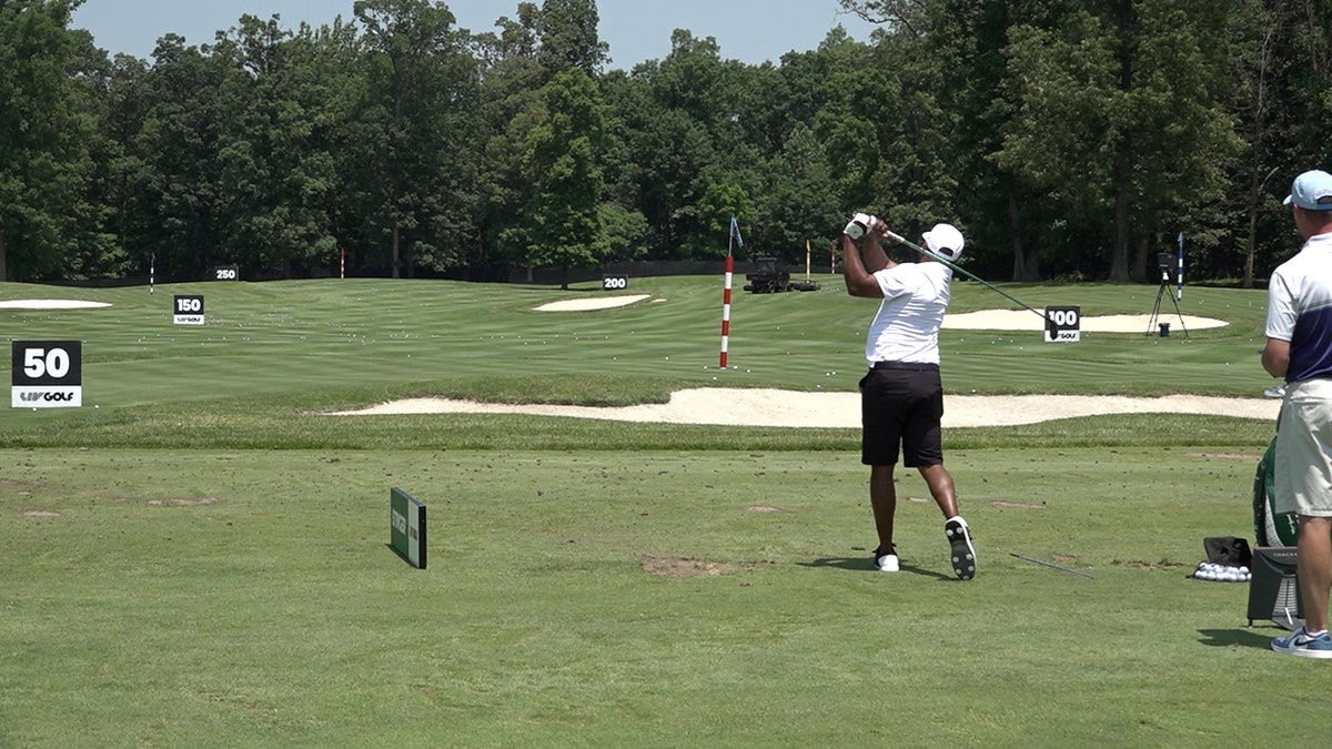 Players at the driving range, ahead of the LIV Golf Virginia event