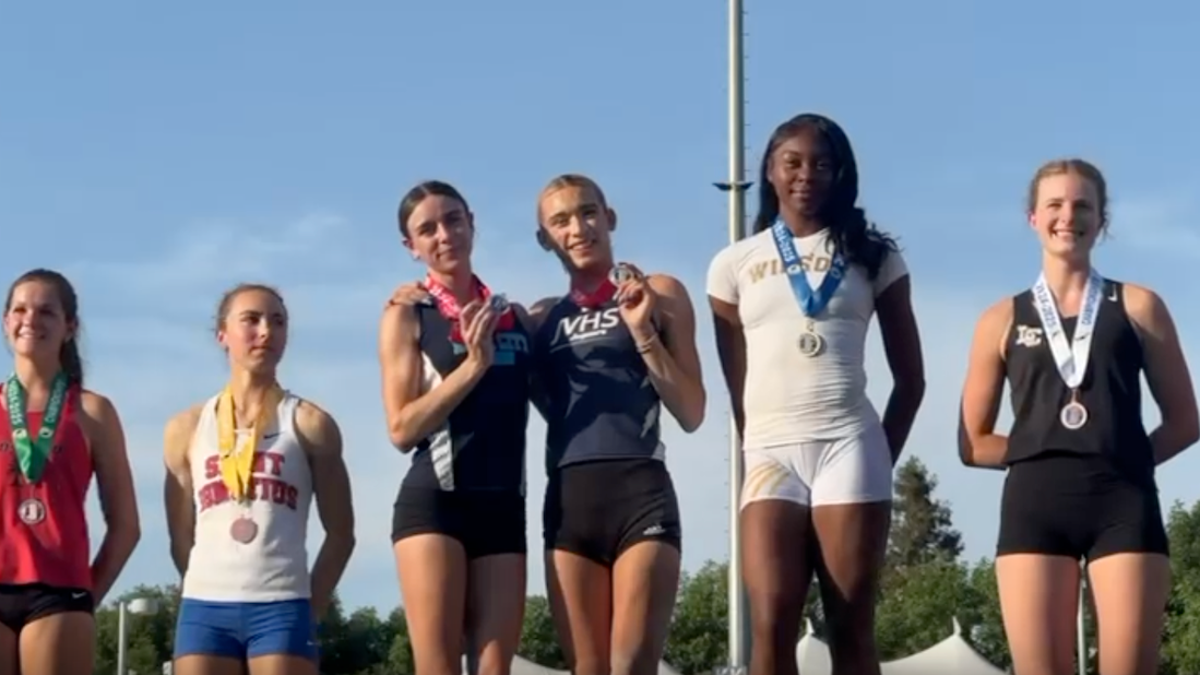 AB Hernandez shares the long jump second-place spot on the medal podium with a female competitor at the California state track and field championship.