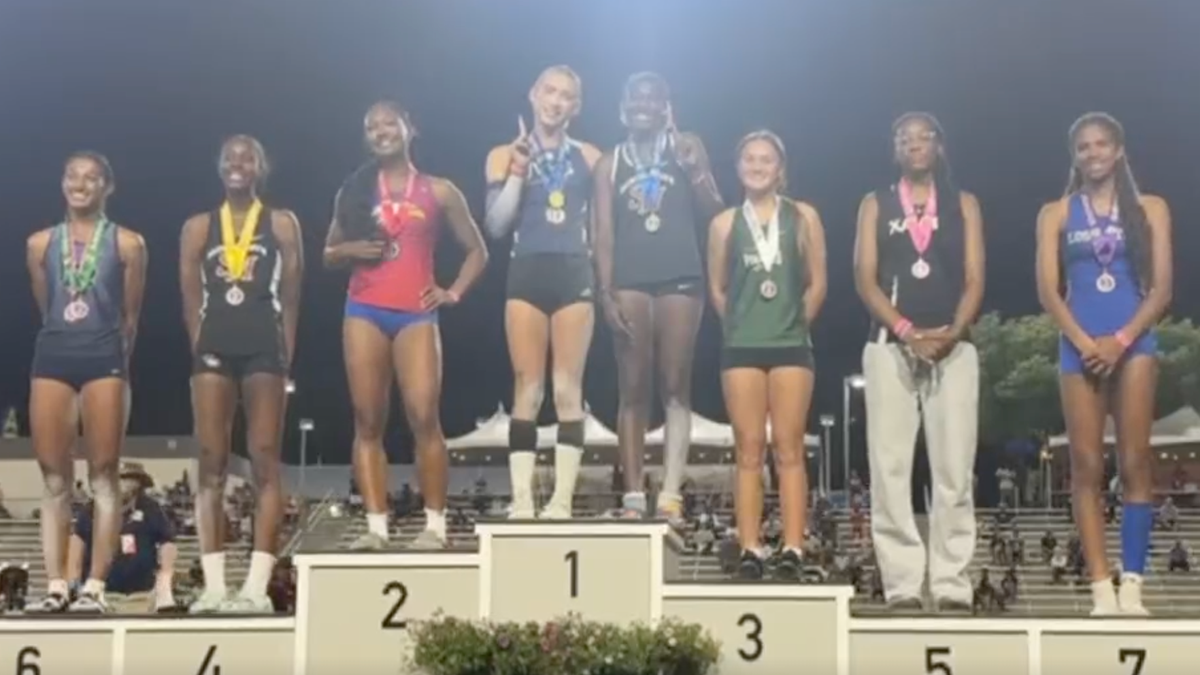 AB Hernandez shares the first-place spot on the triple jump podium at the California track and field state championship with a female competitor.