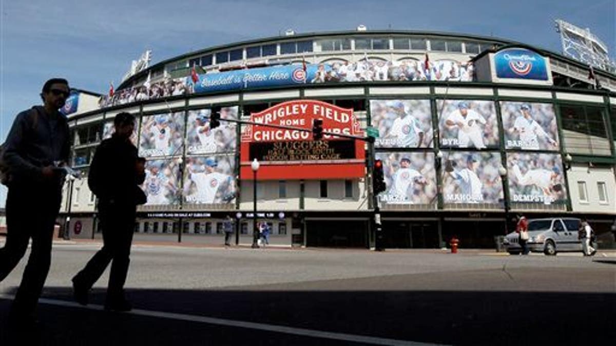 April 4, 2012: People walk by the Marquee at Wrigley Field, one day before the Chicago Cubs' home opener against the Washington Nationals in Chicago.
