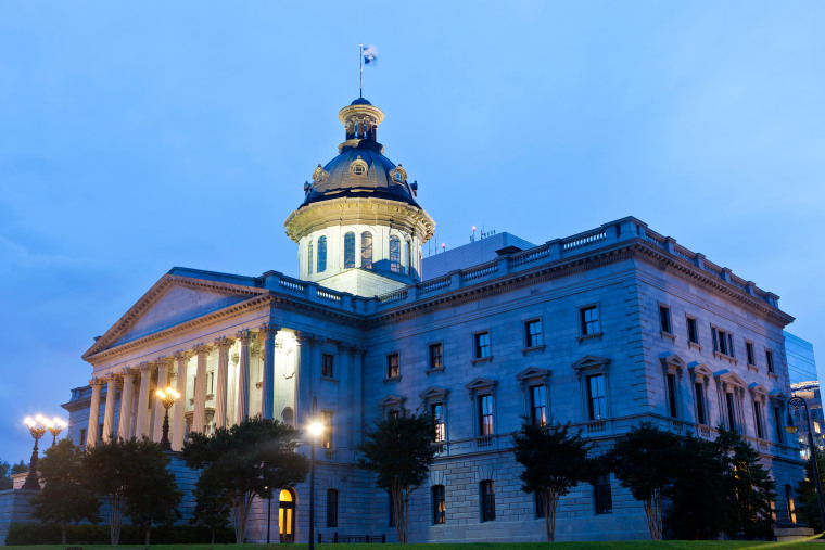 The state house lit up at night.