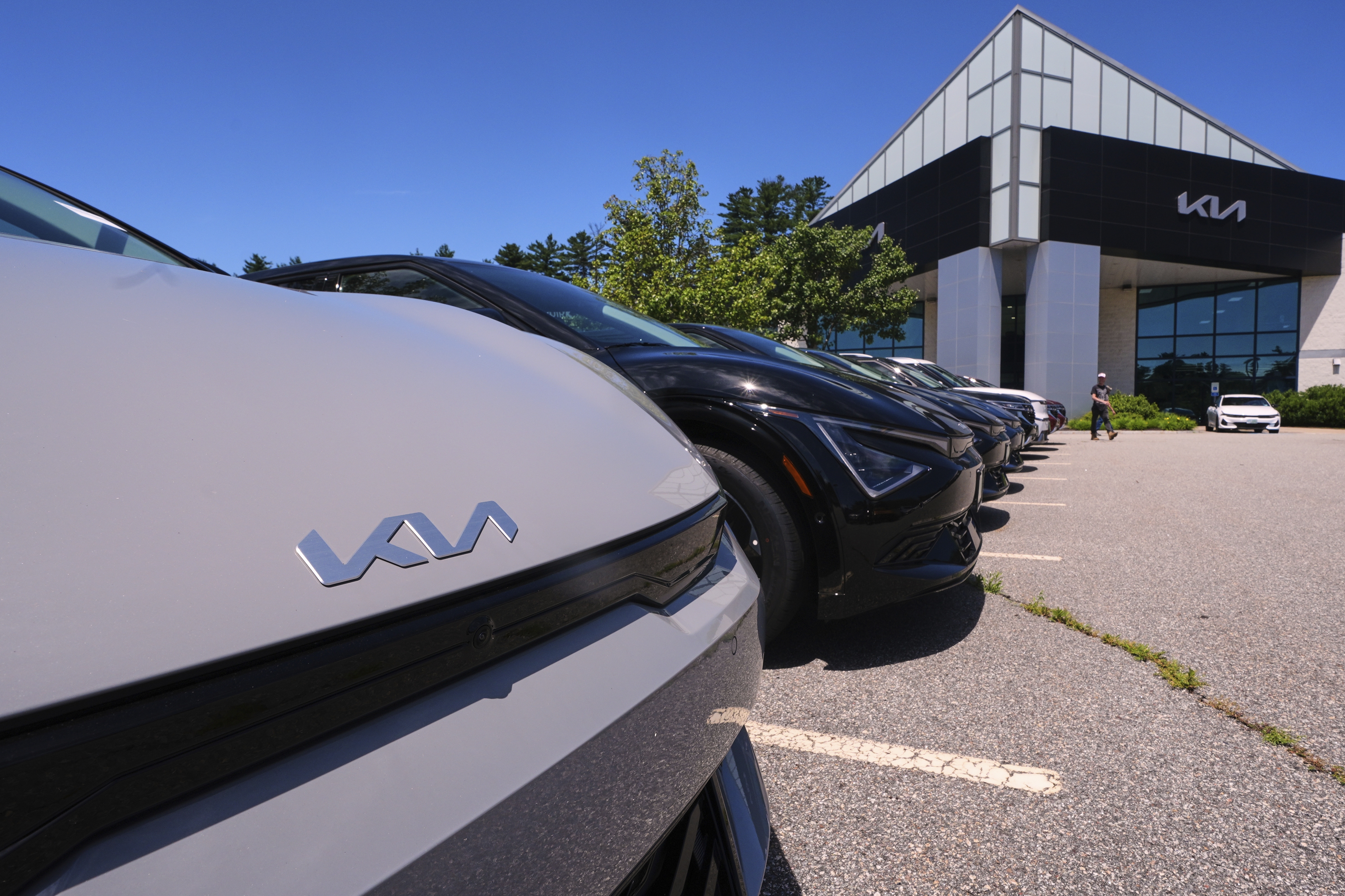 A selection of Kia EV6 electric sedans are displayed at a dealership in Manchester, N.H., in July. The EV6 is eligible for a federal tax credit worth up to $7,500 for buyers under a certain income cap. And like all electric vehicles, it