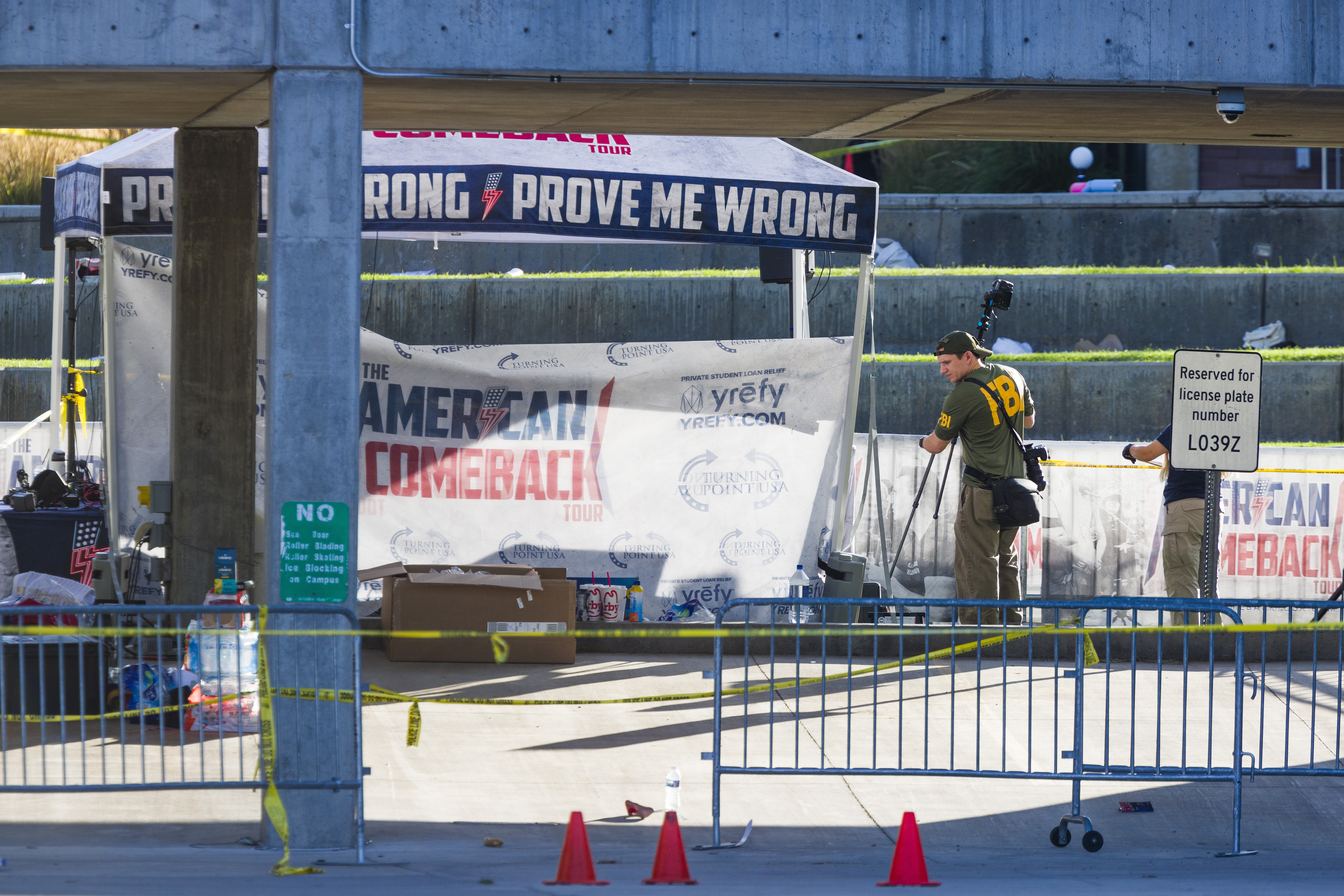 FBI agents walk through the courtyard at Utah Valley University at the site of where political activist Charlie Kirk was killed on Sept. 11, 2025, in Orem, Utah.