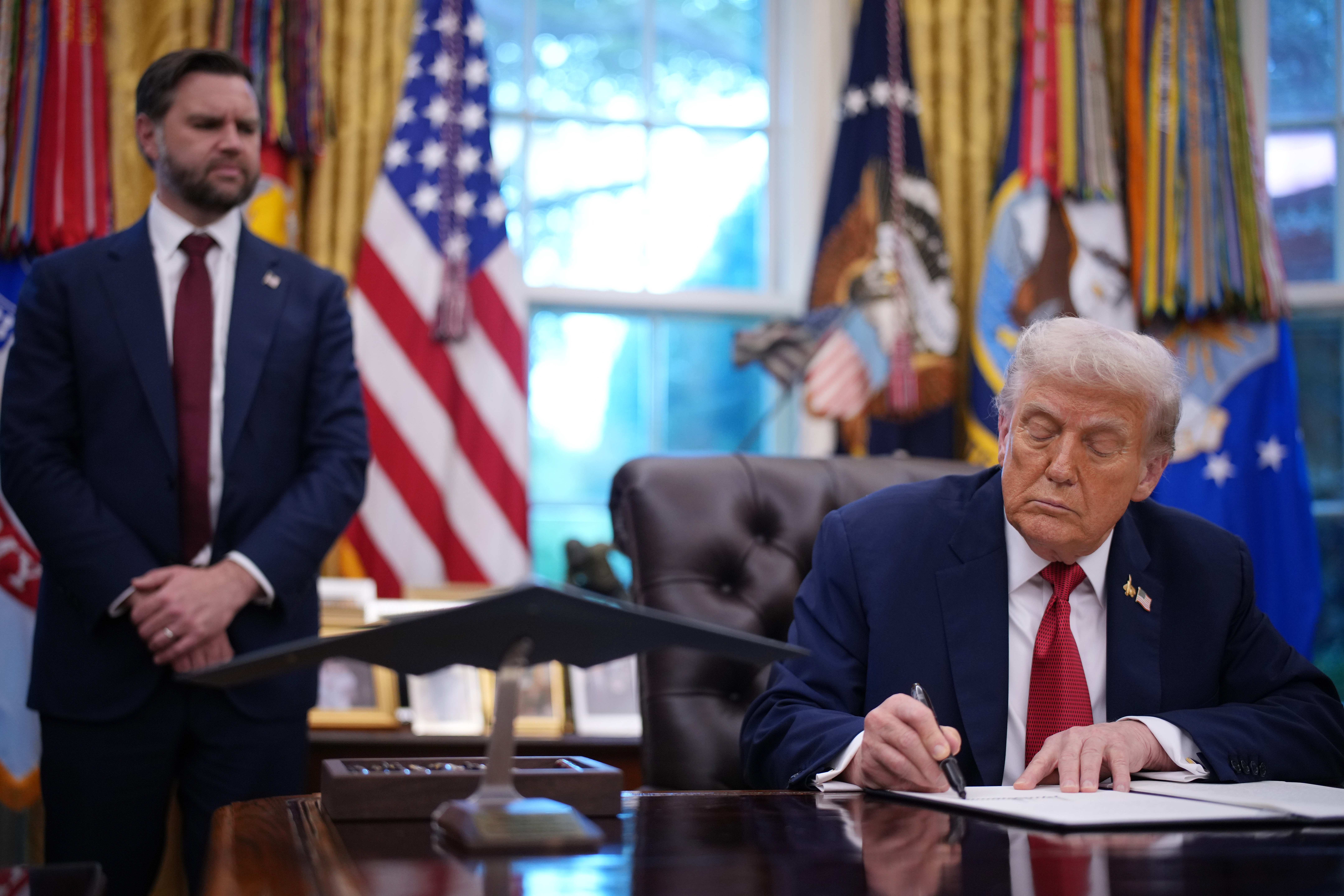 Vice President Vance looks on as President Trump signs an executive order in the Oval Office on Thursday in Washington, D.C. Trump signed an order approving a partial sale of TikTok
