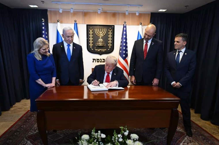 President Trump signs the official guest book at the Israeli Prime Minister Benjamin Netanyahu's office inside the Knesset in Jerusalem.