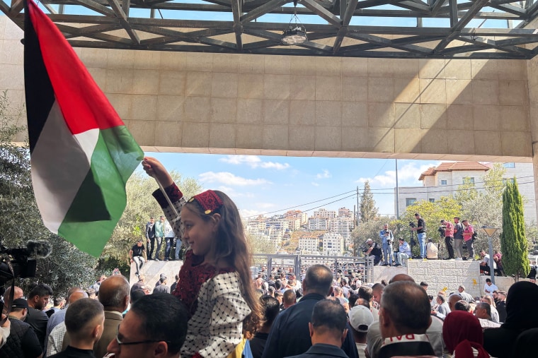Families wait outside the Ramallah Cultural Palace for the Palestinian prisoners to be released Monday.