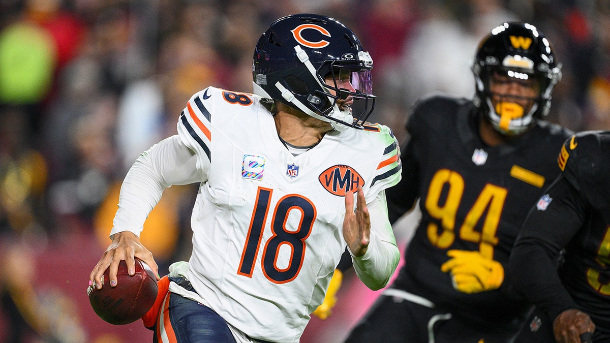 Caleb Williams runs from Daron Payne
