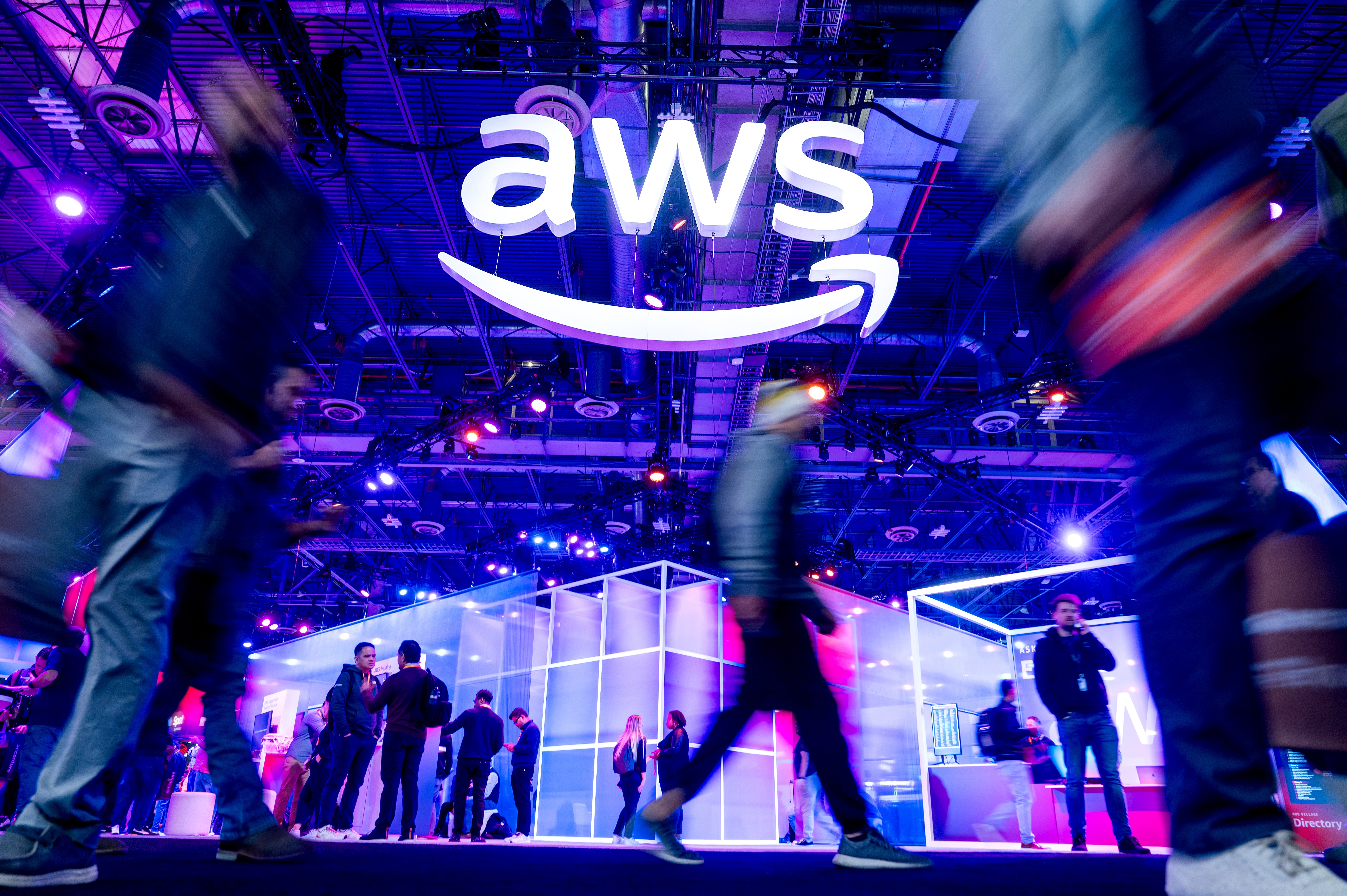 Attendees walk through an expo hall at a conference hosted by Amazon Web Services at The Venetian in Las Vegas on Nov. 28, 2023. AWS is responsible for infrastructure supporting websites across the internet.