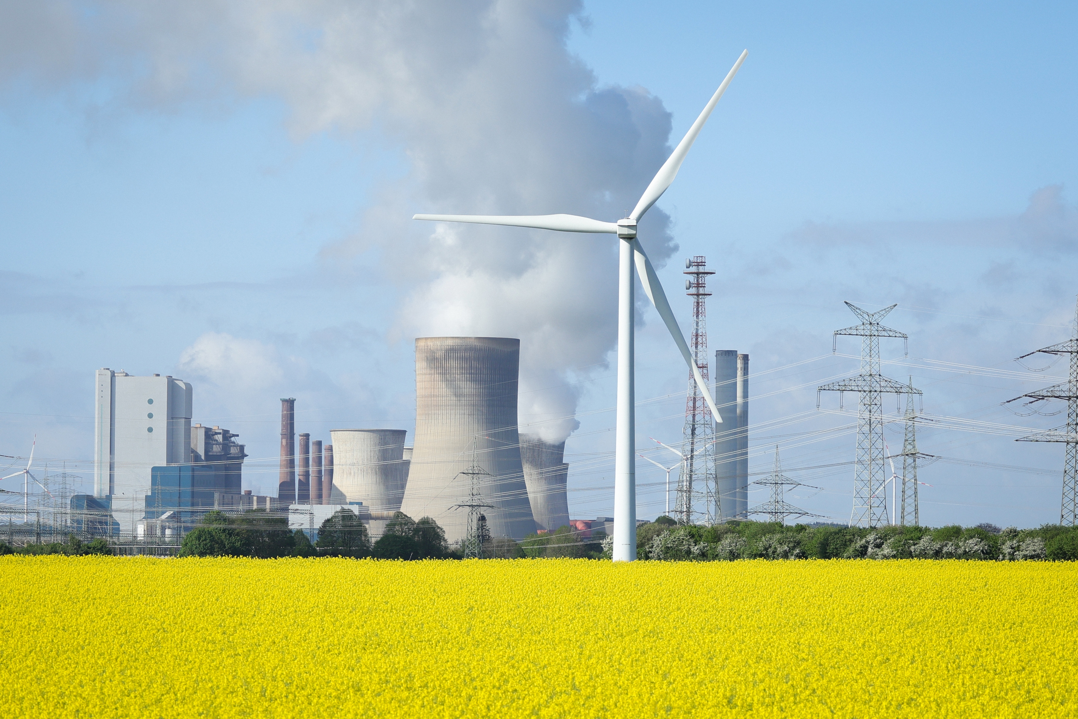 Wind turbines stand next to the Neurath coal-fired power plant on April 15, 2024, in Ingendorf, Germany.