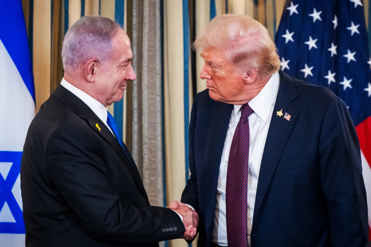 President Donald Trump and Israel's Prime Minister Benjamin shake hands.
