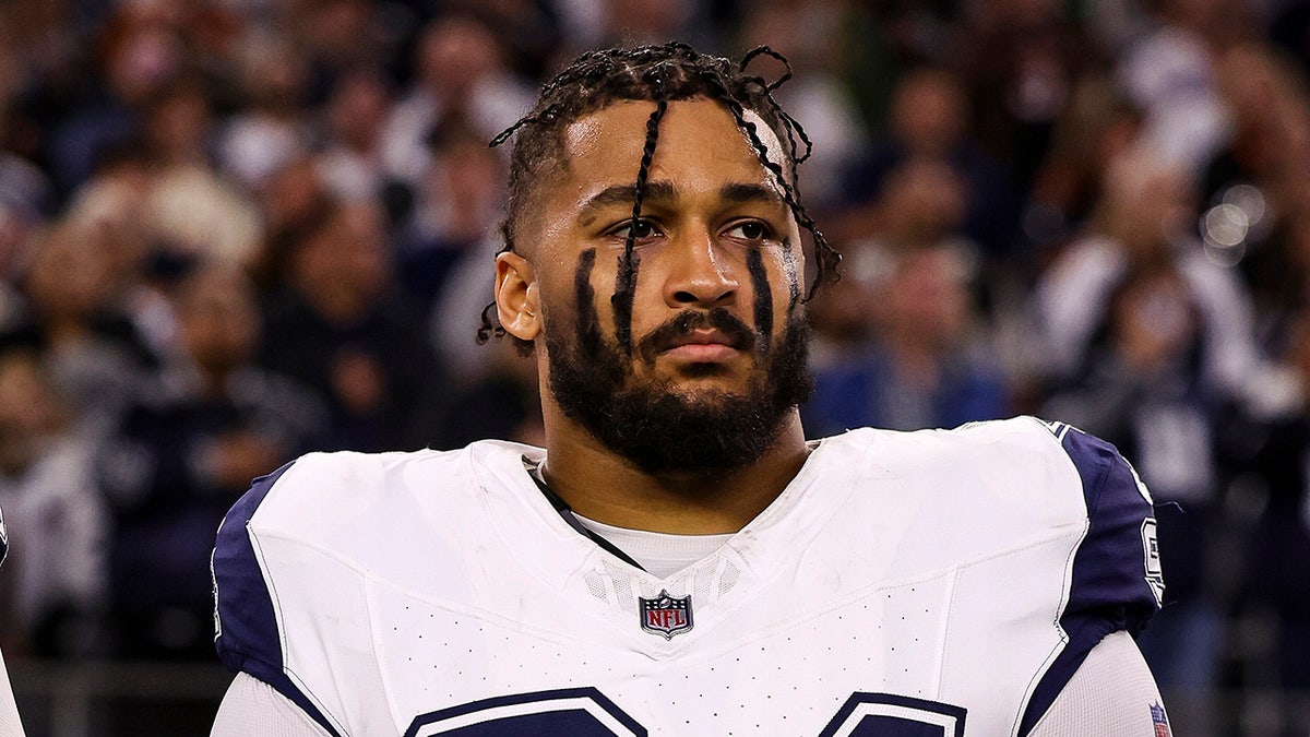 Marshawn Kneeland looks on