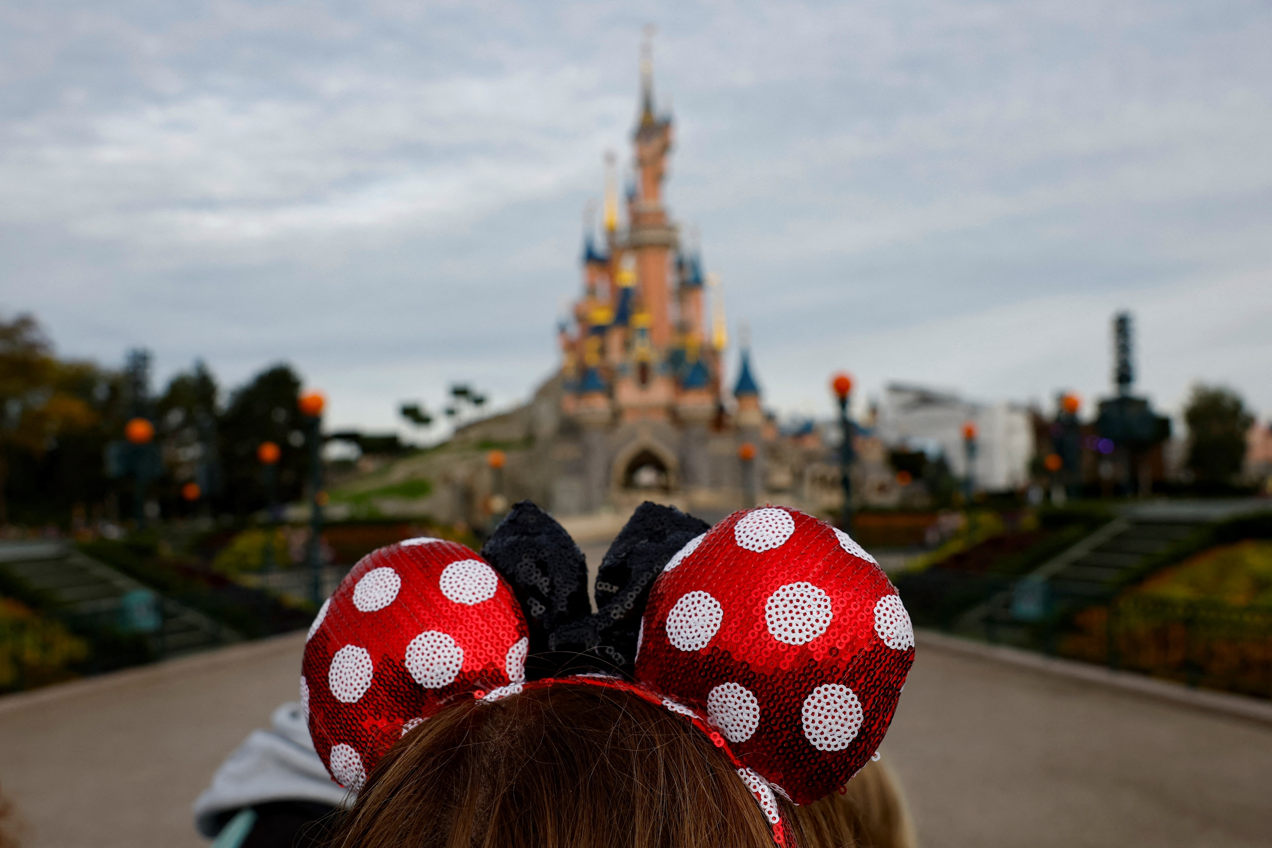In an earnings call on Nov. 13, Disney CEO Bob Iger hinted at working with AI companies to create user-generated content on Disney+ to increase engagement with subscribers. Above, a visitor at Disneyland Paris in 2023.