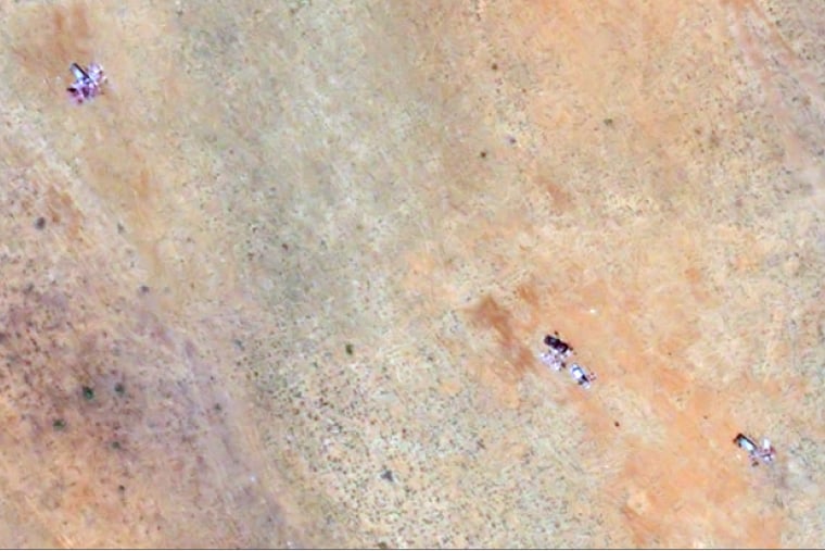 Objects consistent with vehicles and human bodies near the berm in el-Fasher, captured on Monday.
