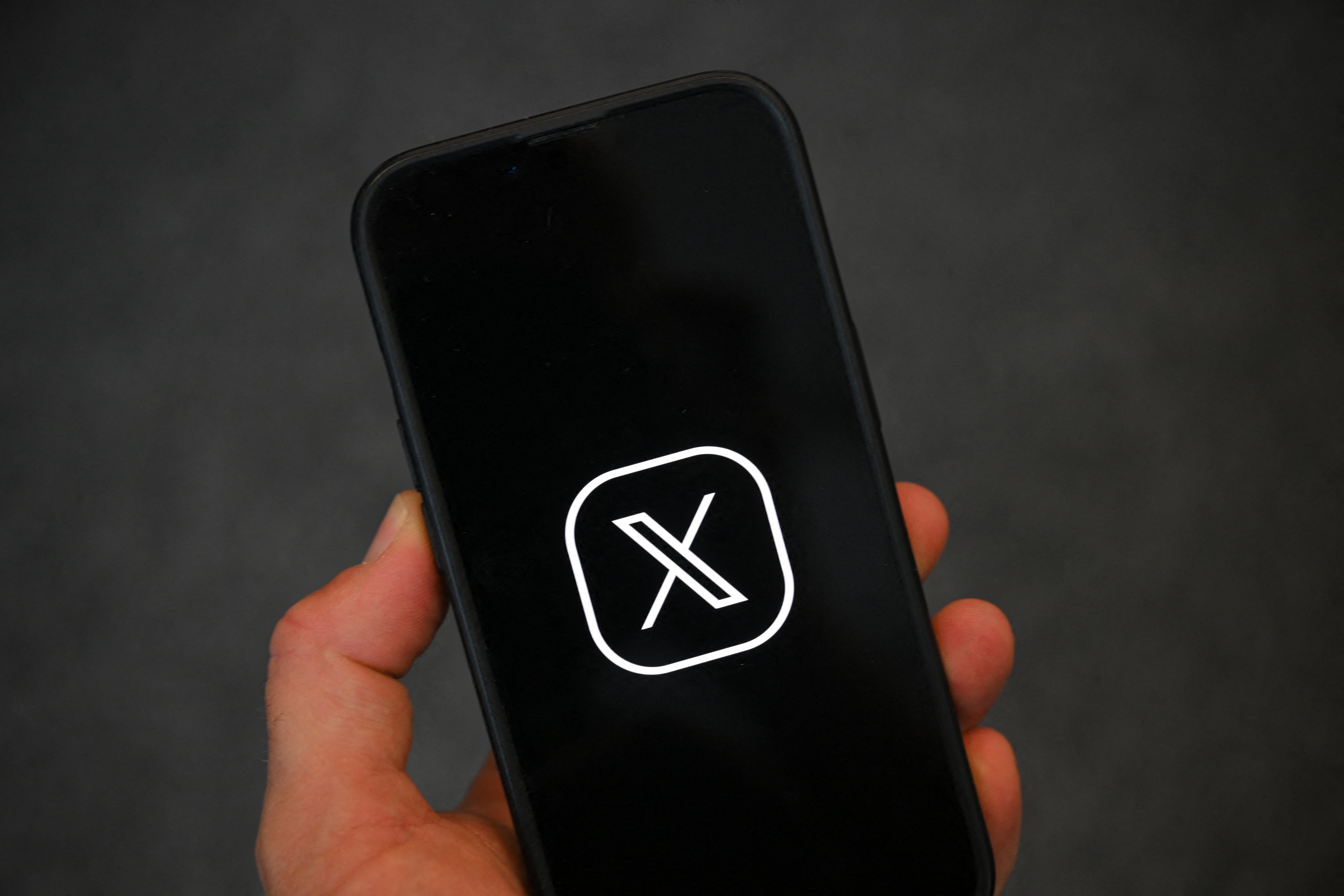 The logo of social network X, formerly Twitter, on a smartphone. A new feature of the site gives more information about where accounts are primarily based from.