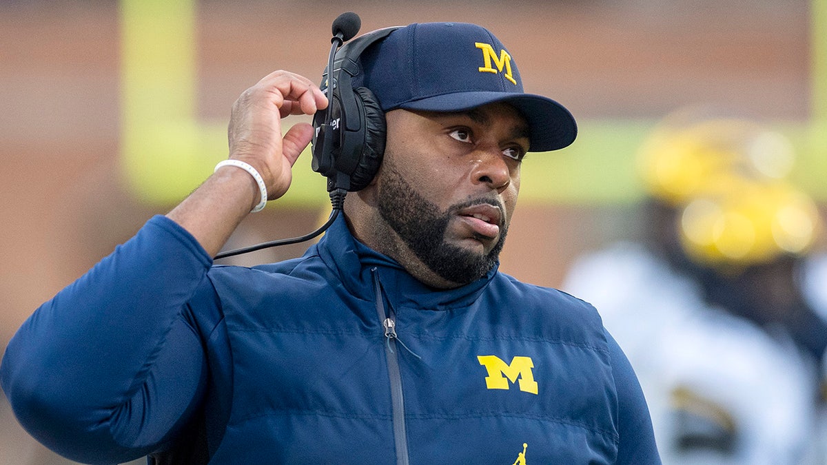 Michigan's Sherrone Moore looks on