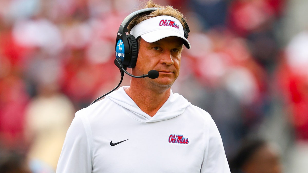 Lane Kiffin walks the sideline