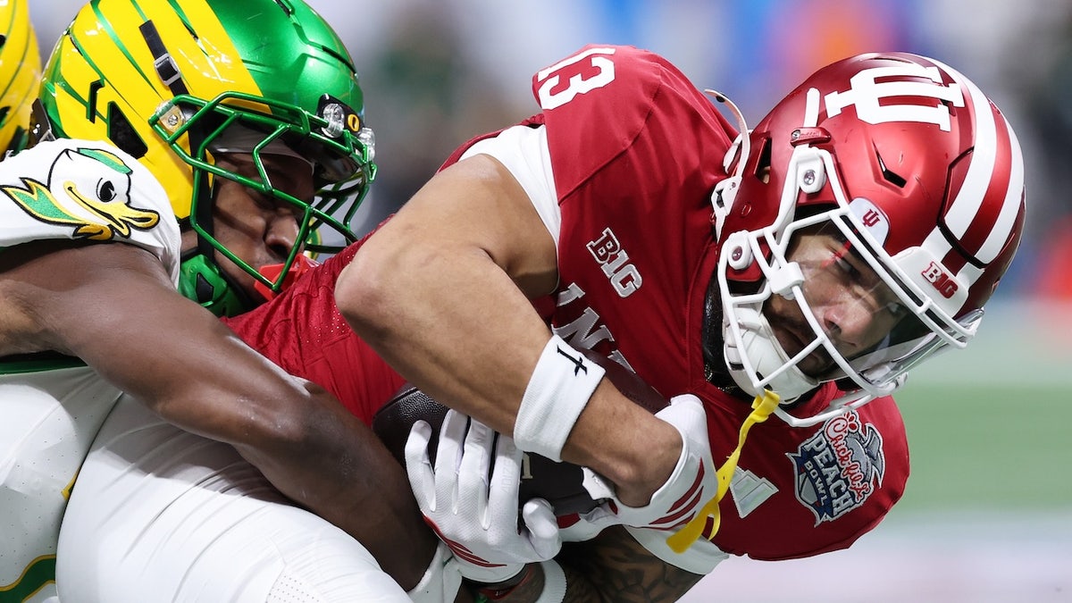 Elijah Sarratt #13 of the Indiana Hoosiers is tackled by Ify Obidegwu #7 of the Oregon Ducks during the first quarter in the 2025 College Football Playoff Semifinal at the Chick-fil-A Peach Bowl at Mercedes-Benz Stadium on January 09, 2026 in Atlanta, Georgia.