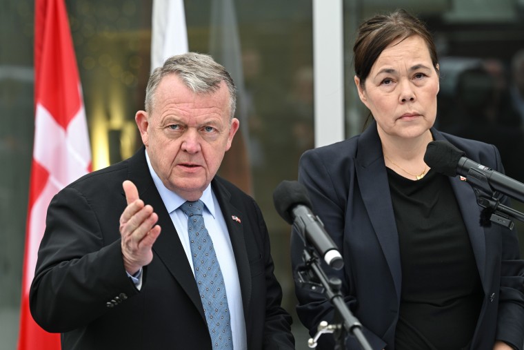 Lars Lokke Rasmussen, left, speaks as Vivian Motzfeldt stands beside him