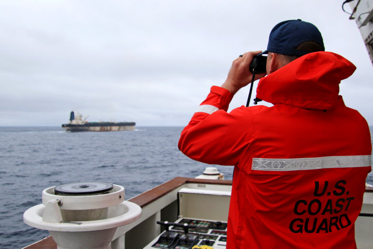 The U.S. European Command shared this image of a U.S. Coast Guard officer monitoring an oil tanker Wednesday.