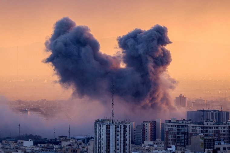 A plume of smoke rises after a strike.