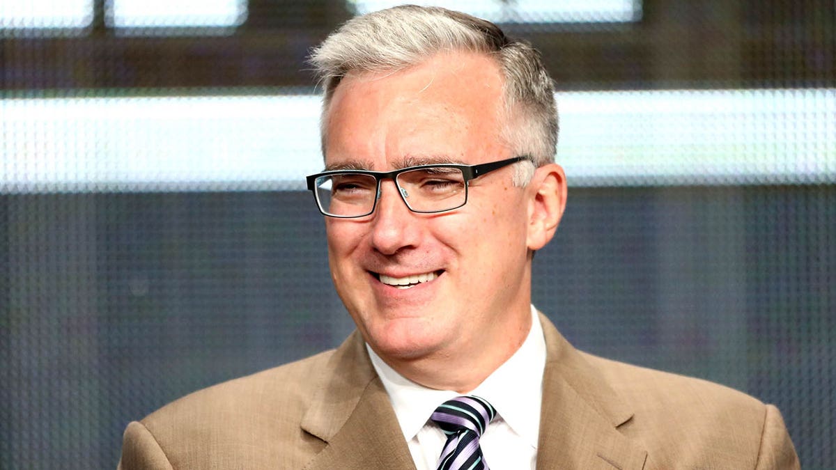 Keith Olbermann looks on