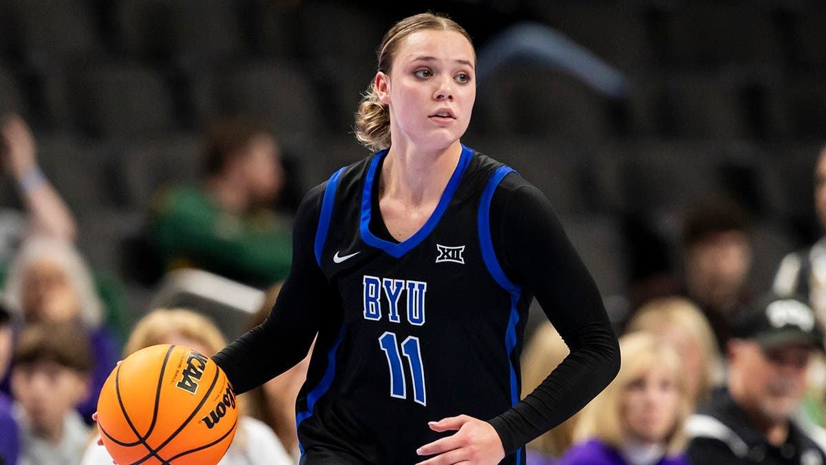 BYU guard Delaney Gibb dribbling basketball during game at T-Mobile Center