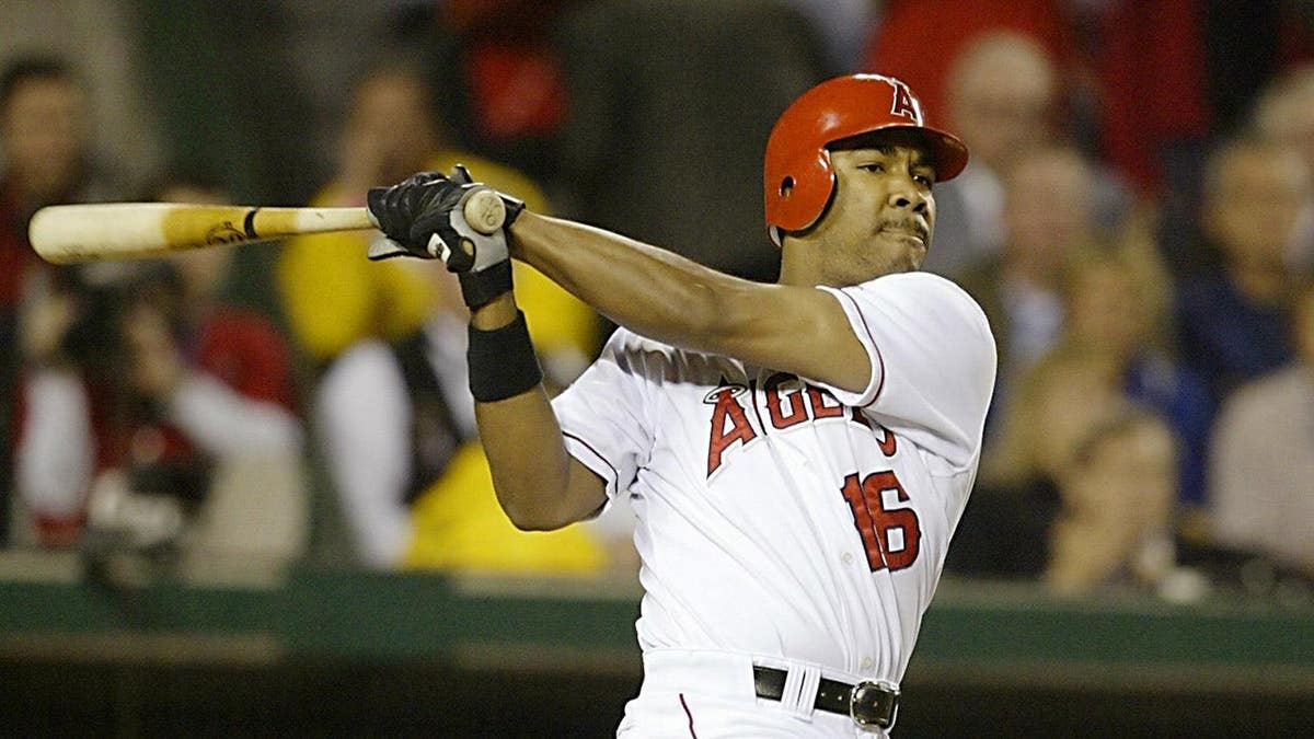 Anaheim Angels Garret Anderson hitting a three-run double during World Series game.