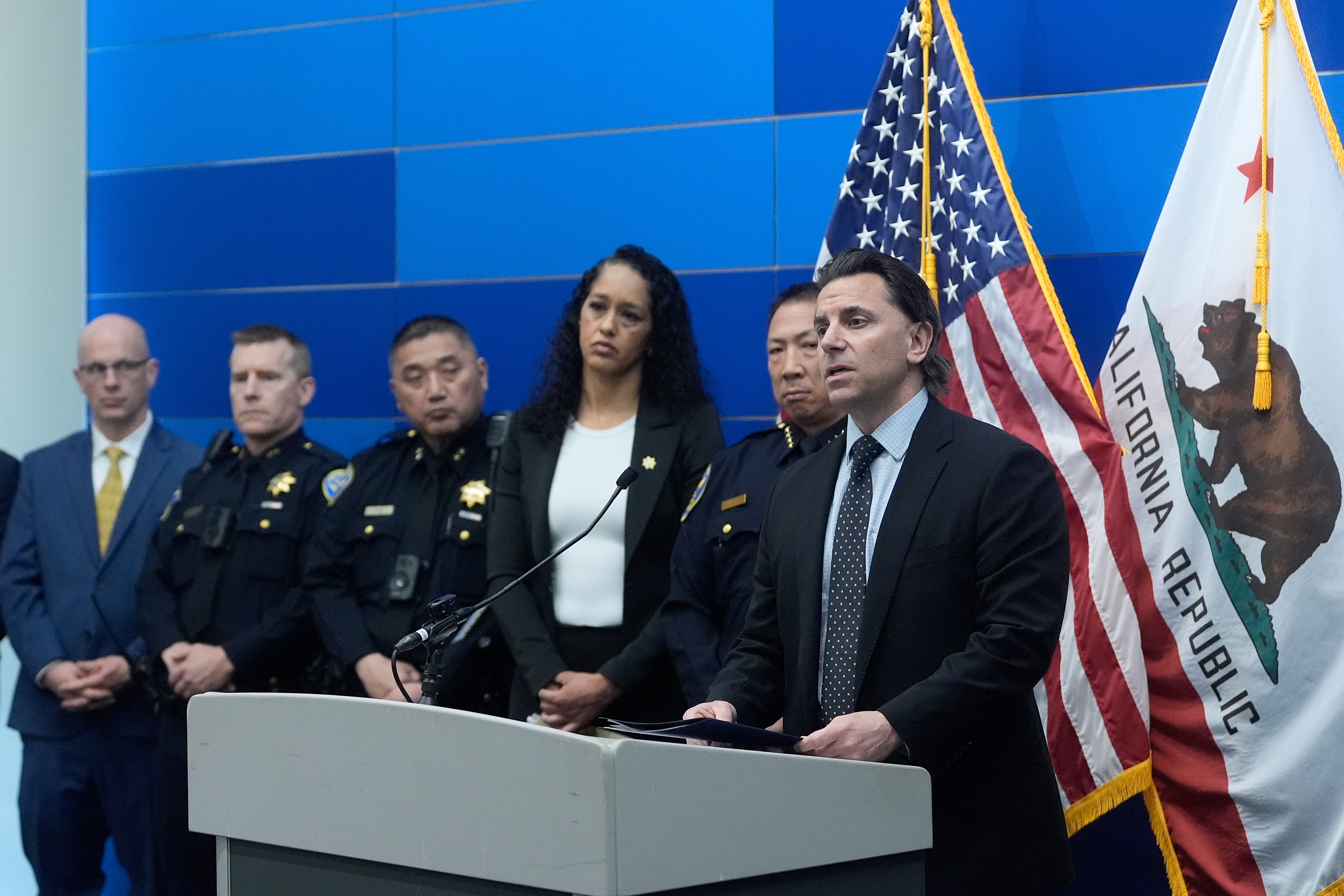 Matt Cobo, F.B.I. San Francisco Acting Special Agent in Charge ( right) speaks next to San Francisco Police Chief Derrick Lew (second from right) and San Francisco District Attorney Brooke Jenkins (third from right) during a news conference Monday, April 13, 2026, in San Francisco.