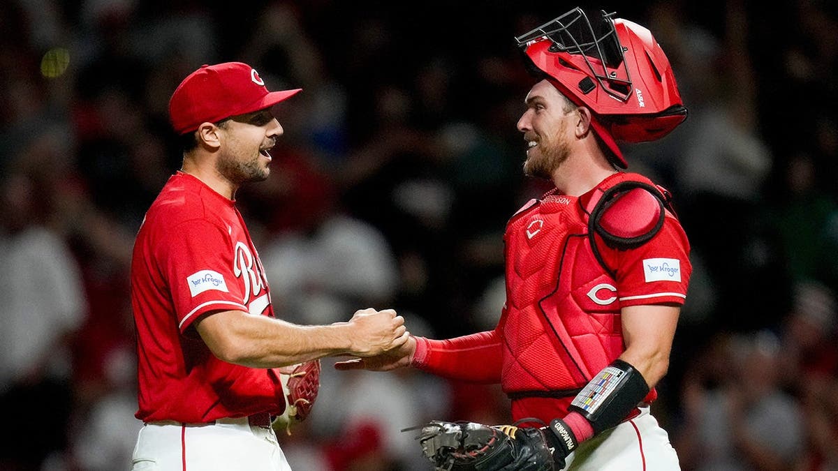 Cincinnati Reds pitcher Brock Burke celebrating with catcher Tyler Stephenson at Great American Ball Park