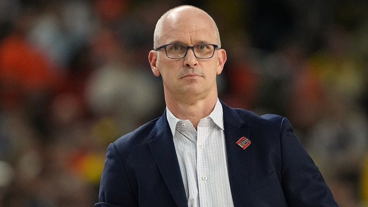 UConn head coach Dan Hurley standing on the sidelines during a basketball game.