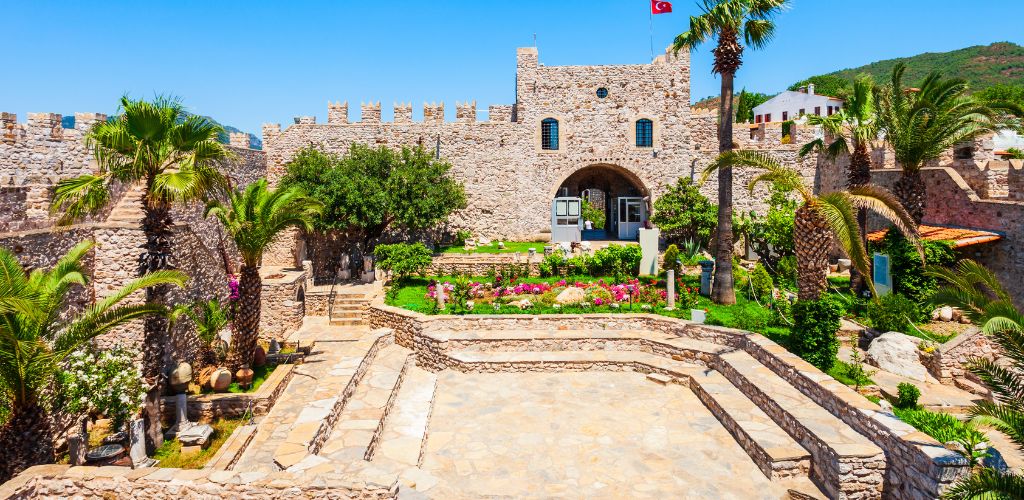 historical castle and a beautiful garden and blue sky.