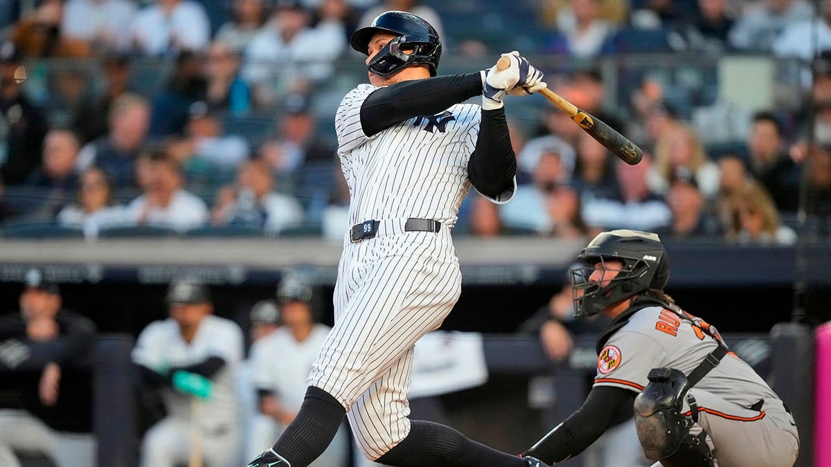 New York Yankees' Aaron Judge hitting a home run during a baseball game.