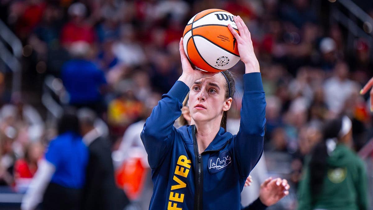 Indiana Fever guard Caitlin Clark warming up on basketball court