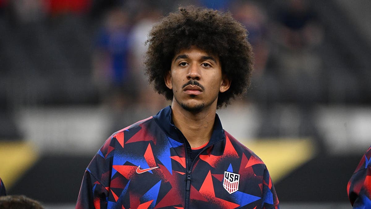 Chris Richards standing on soccer field wearing United States uniform