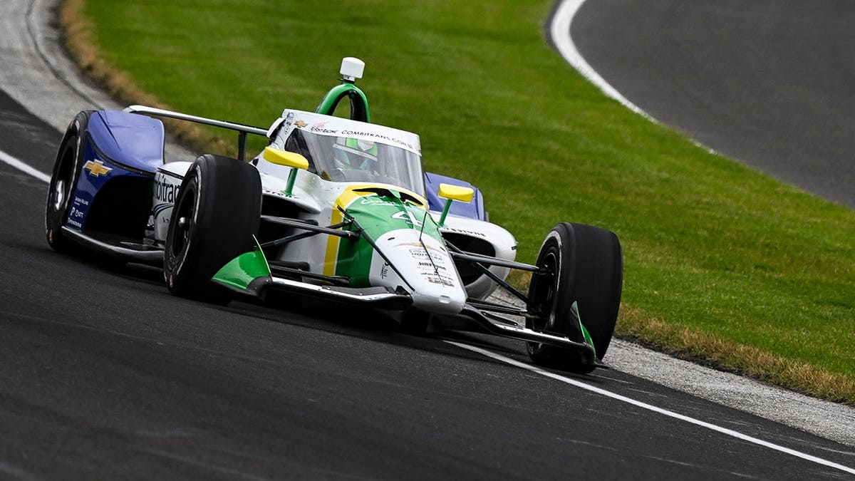 Caio Collet driving a Chevrolet race car on a track at Indianapolis Motor Speedway