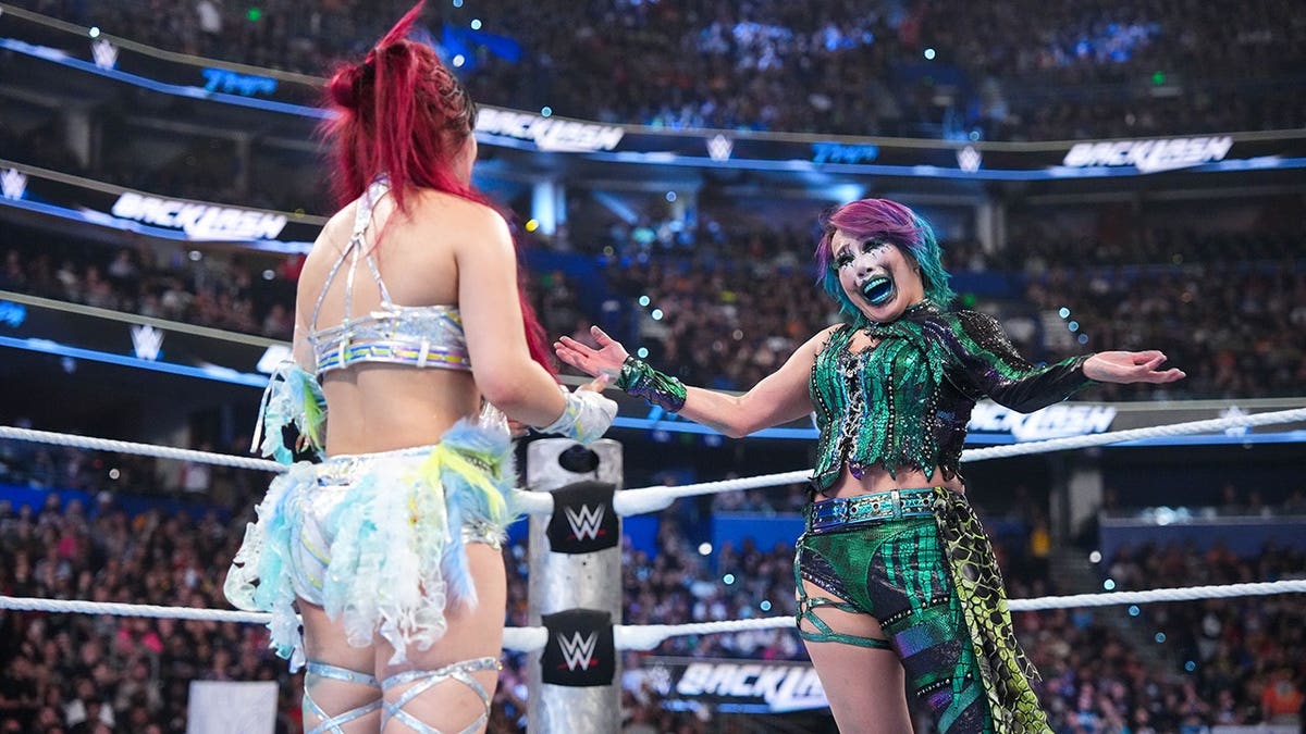 IYO SKY and Asuka embracing during WWE Backlash event in Tampa, Florida