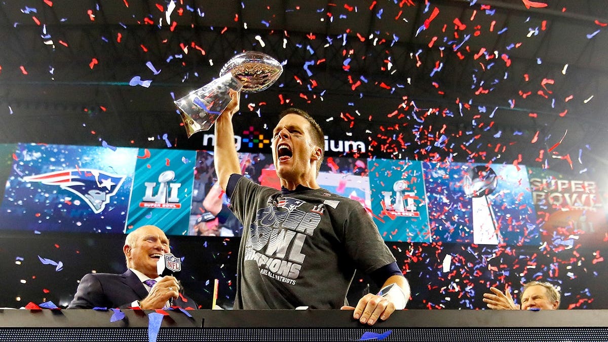 Tom Brady holding the Vince Lombardi Trophy at NRG Stadium in Houston