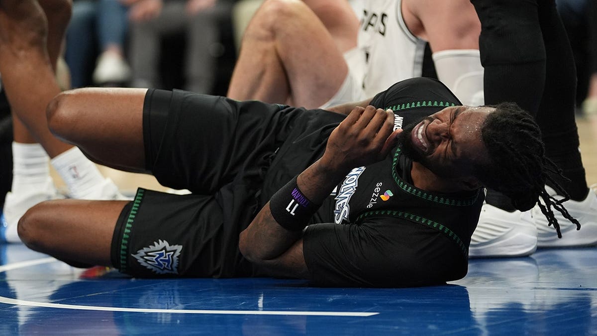 Minnesota Timberwolves center Naz Reid reacting to injury during basketball game