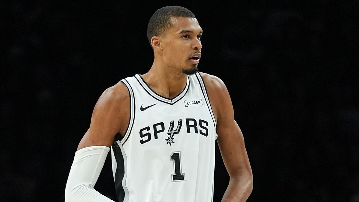 San Antonio Spurs forward Victor Wembanyama walking across basketball court after foul