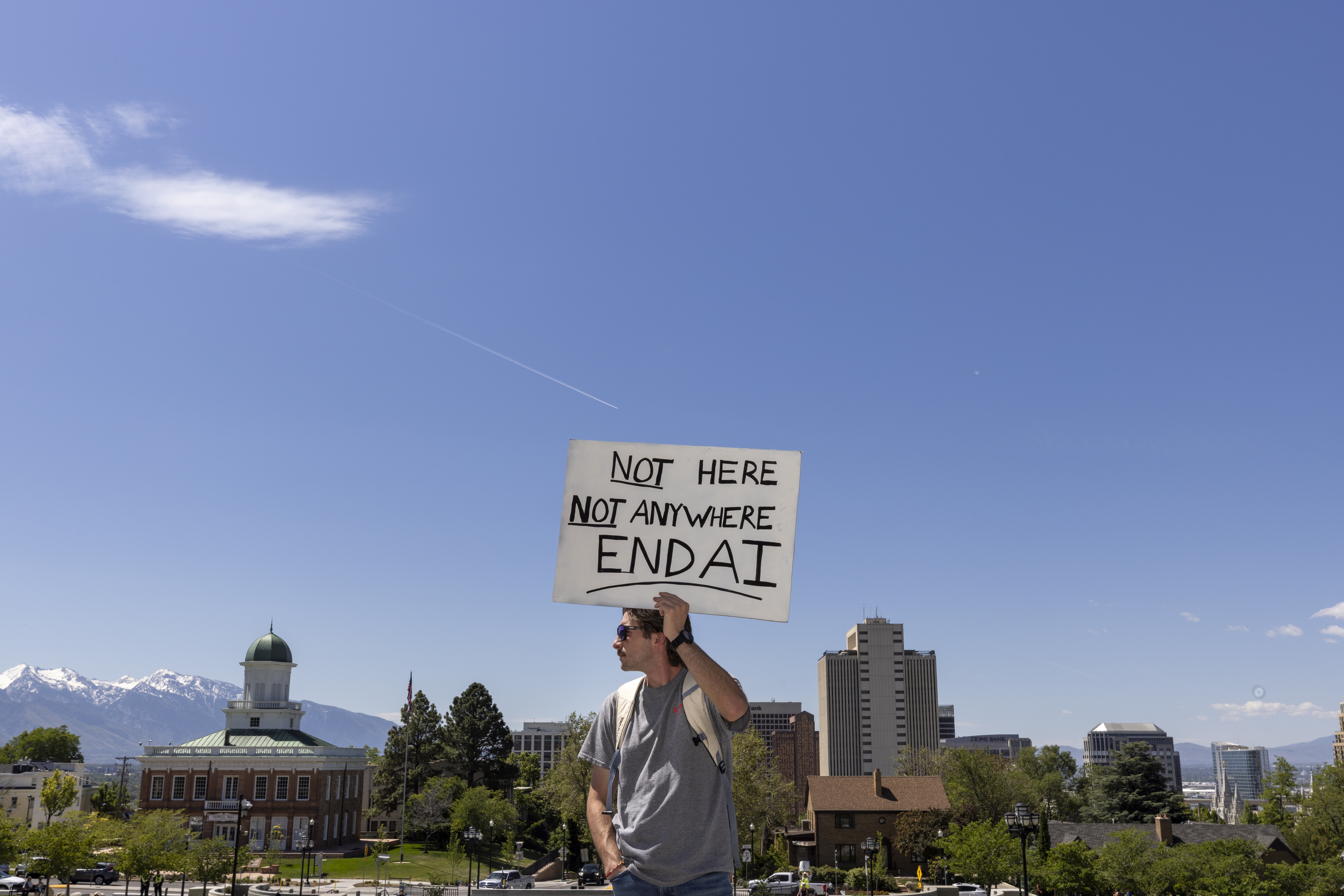 Scott Kwiatkowski takes part in a demonstration on May 23 at the Utah state Capitol in Salt Lake City to oppose construction of a data center in the state. Support and opposition to artificial intelligence are drawing tens of millions of dollars of spending during the midterm election cycle.