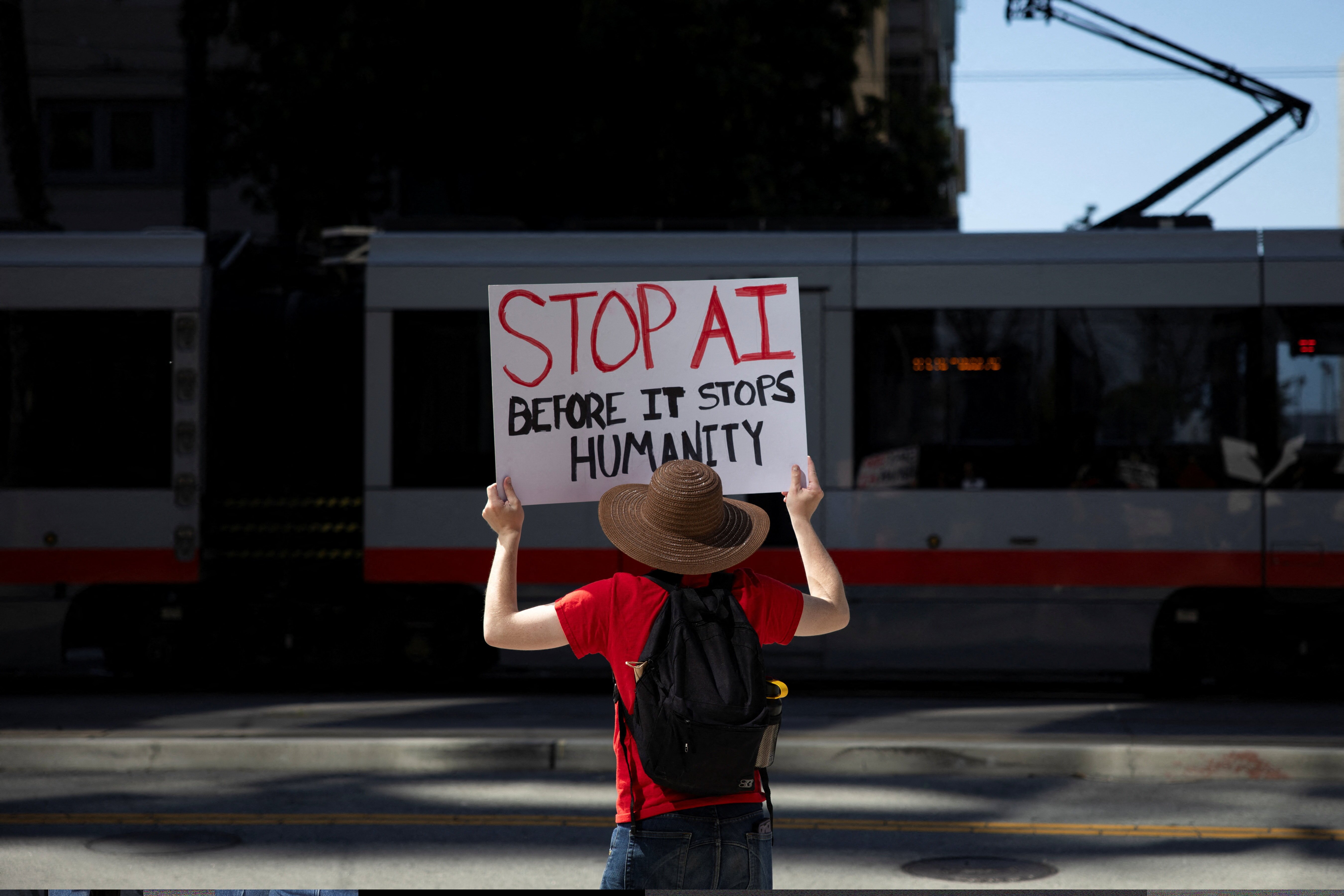 A protester holds a sign during a protest outside of OpenAI headquarters calling for a pause in AI development in San Francisco on March 21.