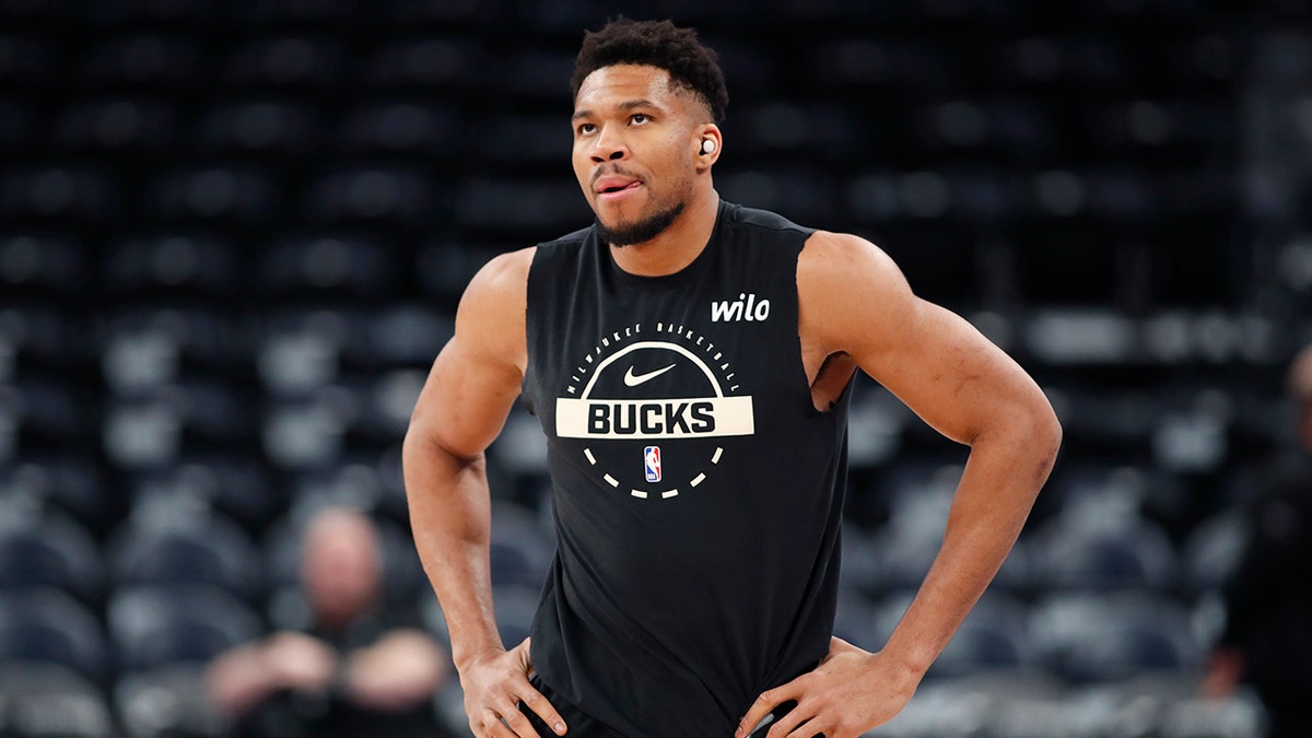 Giannis Antetokounmpo walking on the basketball court during warmups.
