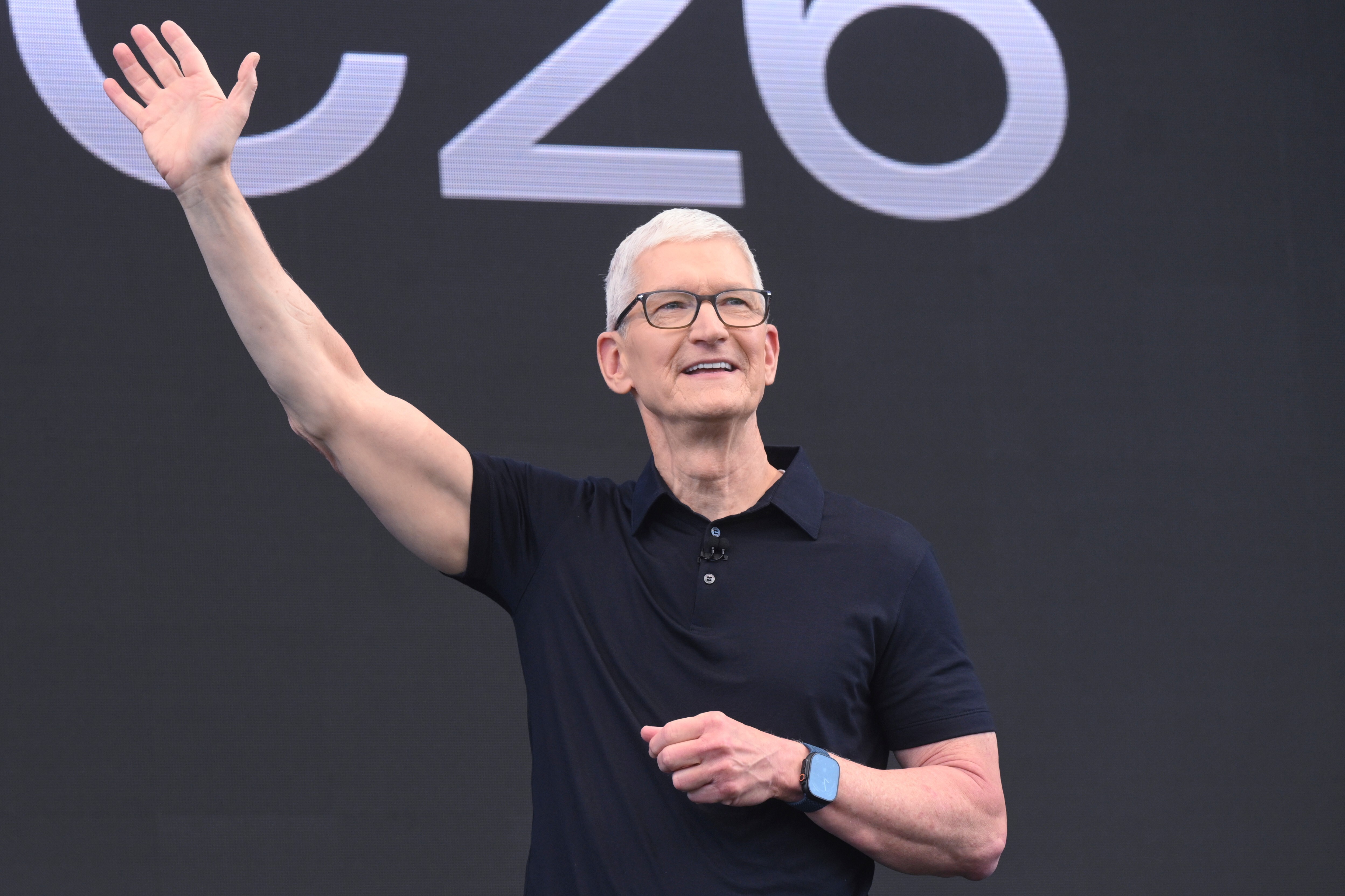 CEO Tim Cook waves during the annual World Wide Developers Conference at Apple