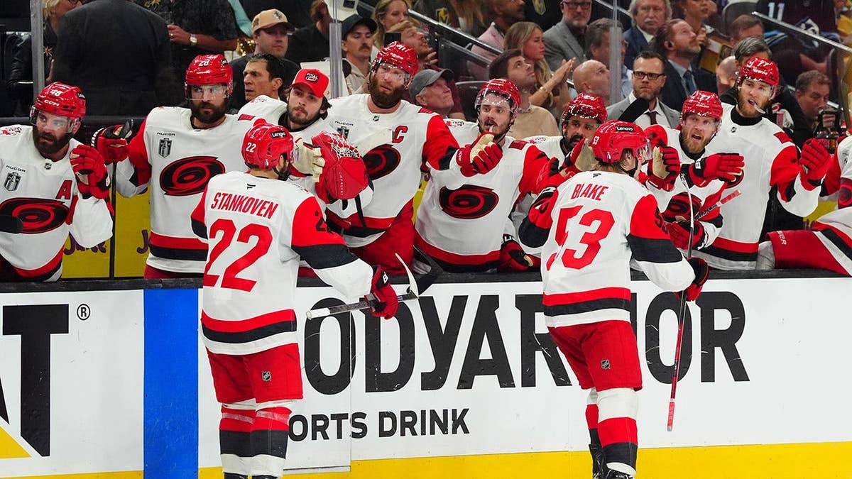 Jackson Blake and Logan Stankoven skating by the bench celebrating a goal at T-Mobile Arena