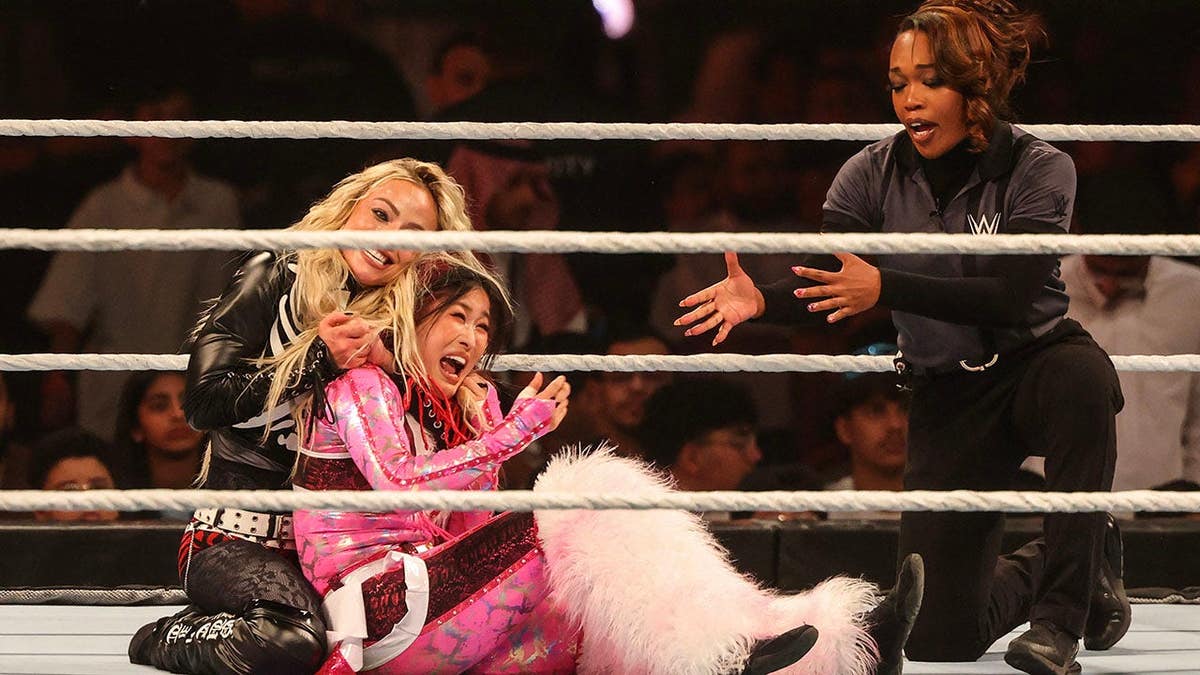 US wrestler Liv Morgan and Japanese wrestler Iyo Sky fighting in a wrestling ring