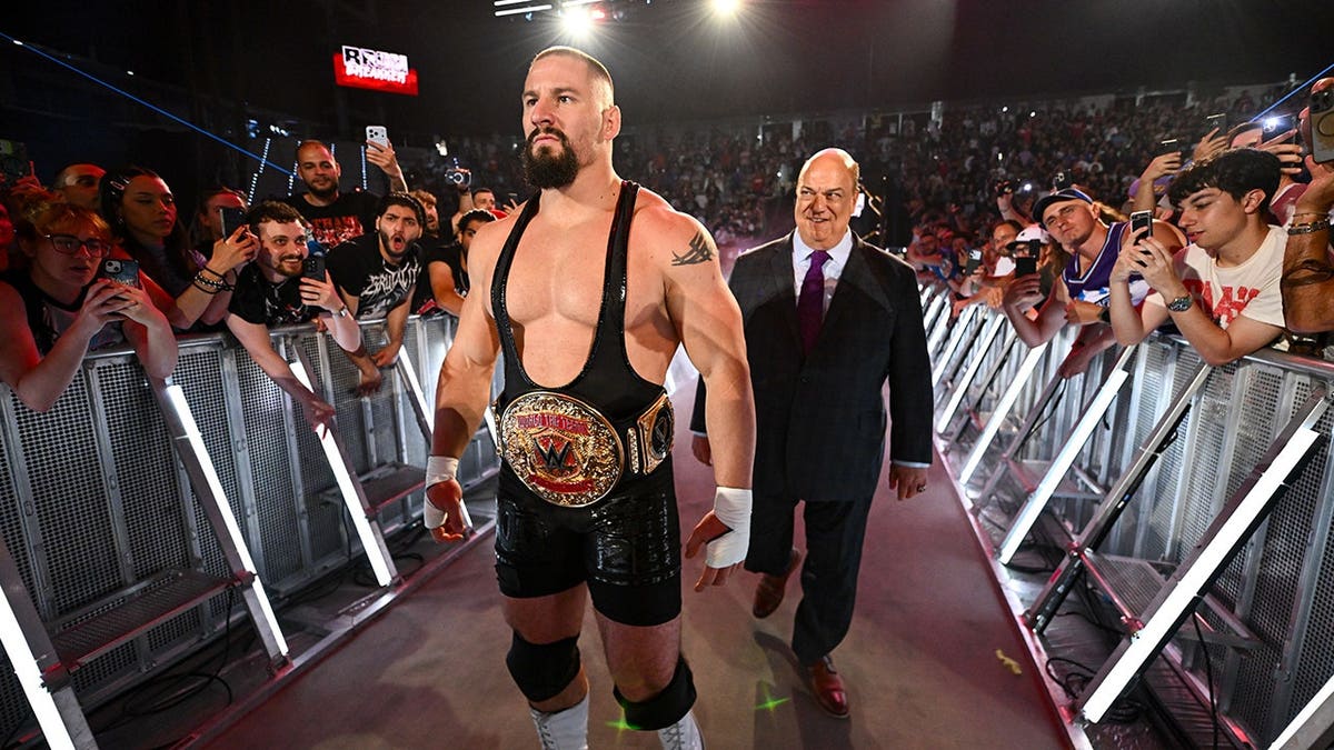 Bron Breakker and Paul Heyman entering the wrestling ring at Inalpi Arena.