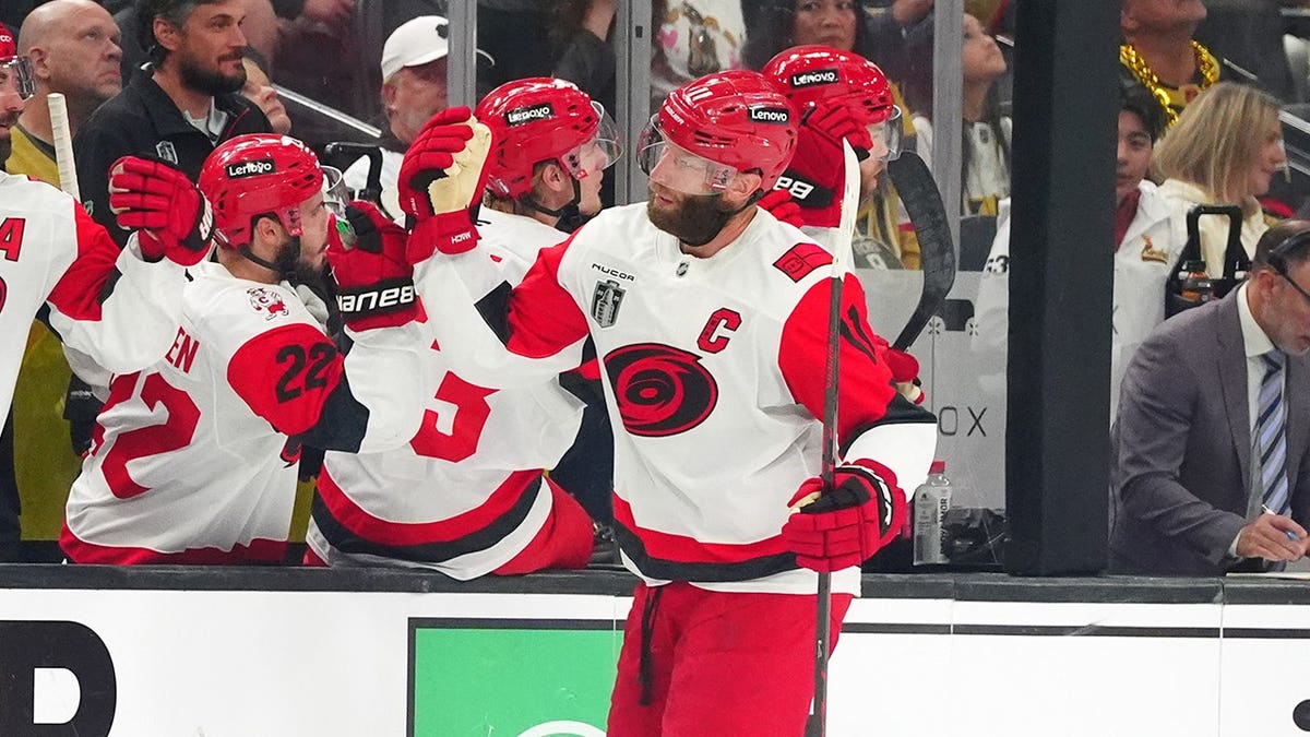 Jordan Staal of the Carolina Hurricanes celebrates a power play goal with teammates on ice.