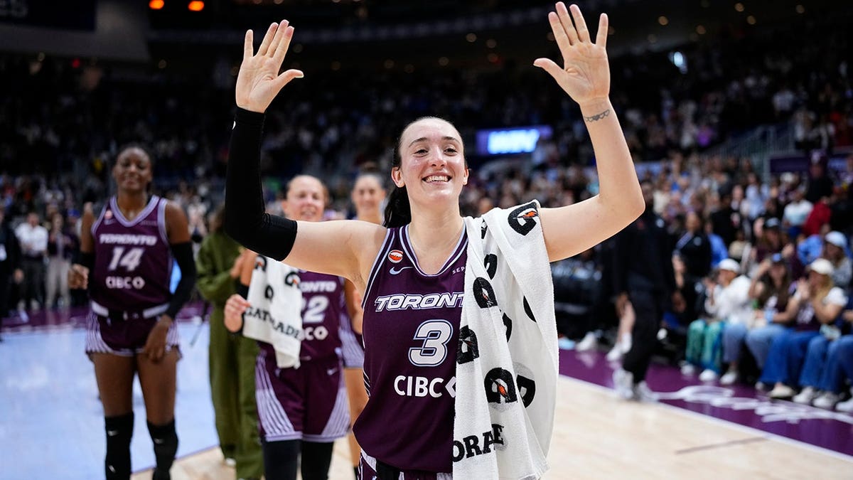 Marina Mabrey celebrating on the basketball court at Coca-Cola Coliseum in Toronto